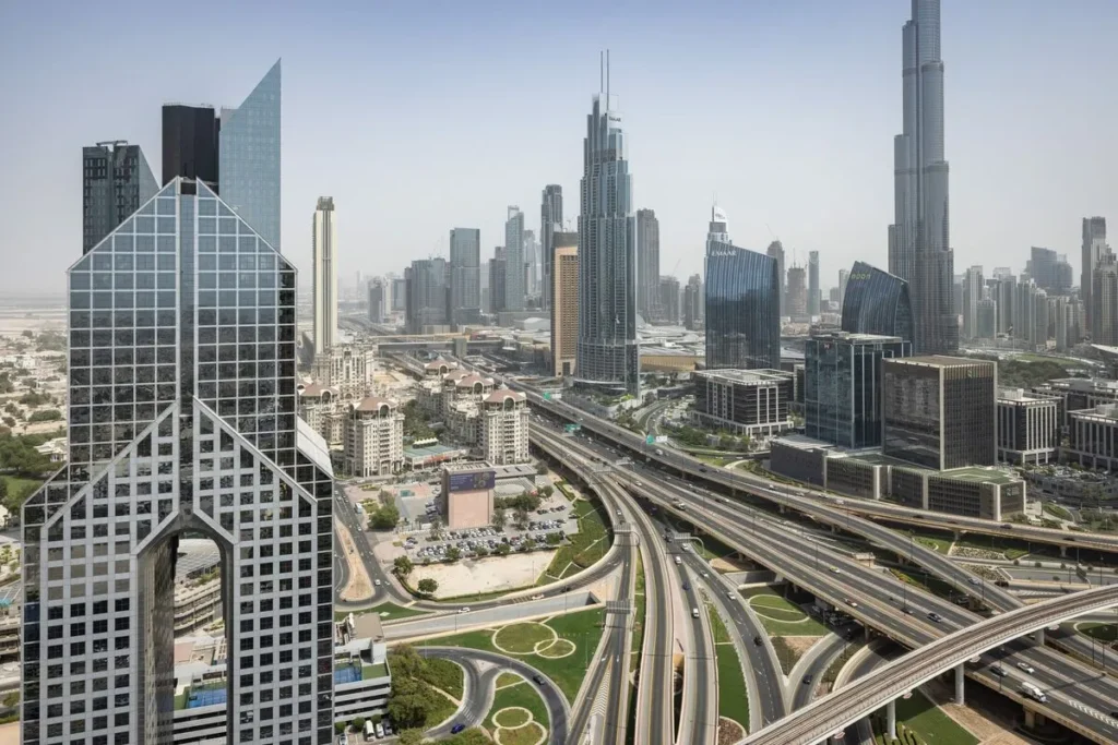 Sheikh Zayed Road Dubai with Emirates Towers and Burj Khalifa skyline &mdash; benefits of buying property in Dubai for Indian investors