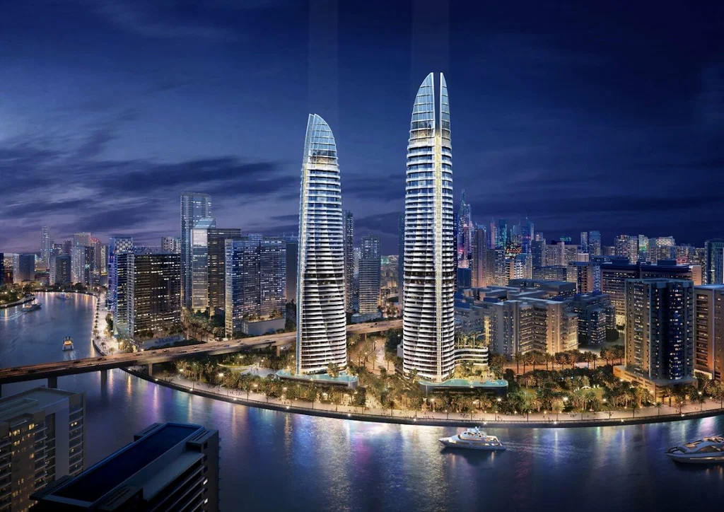 Sobha Seahaven twin towers at Dubai Harbour waterfront at night — benefits of buying property in Dubai for Indian investors